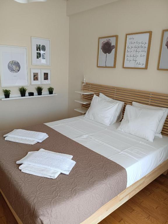 a bedroom with a large bed with two towels on it at Like at home in Perea