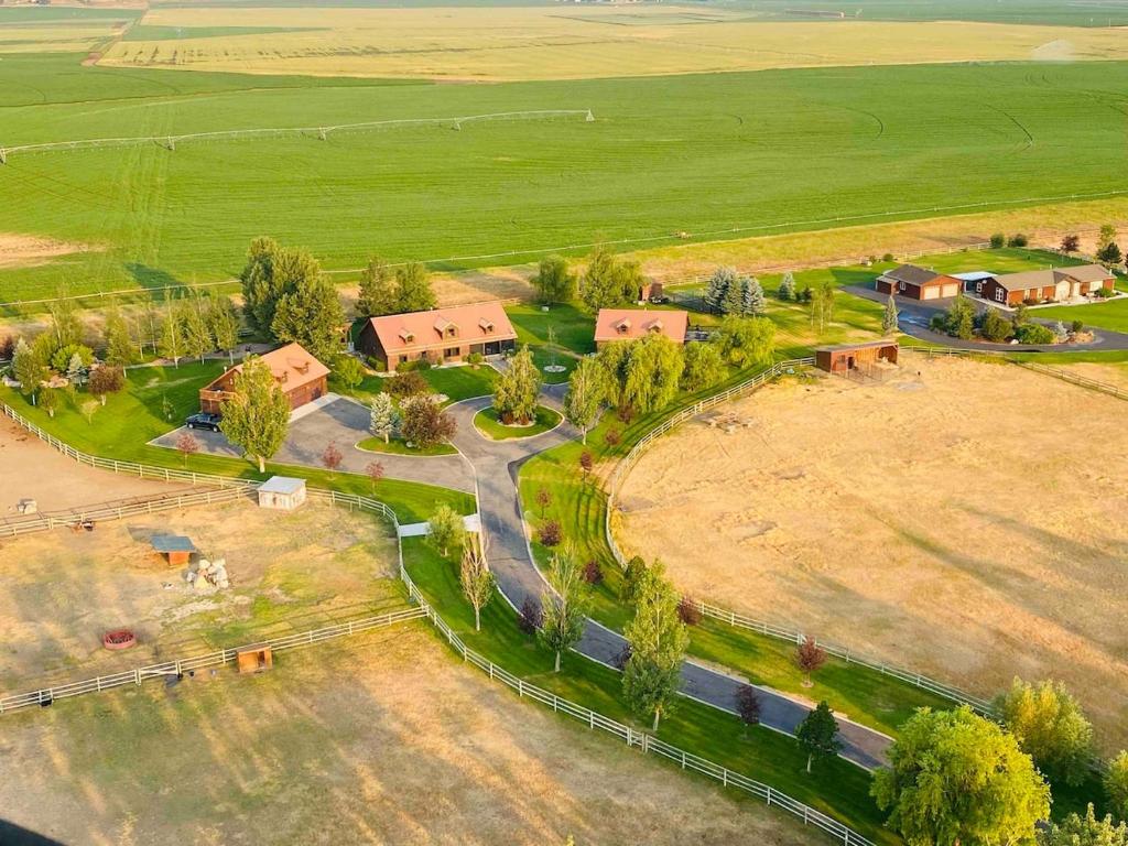 an aerial view of a farm with trees and a road at 2 Bedroom Loft on Horse, Goat, Donkey and Cow Farm in Bozeman
