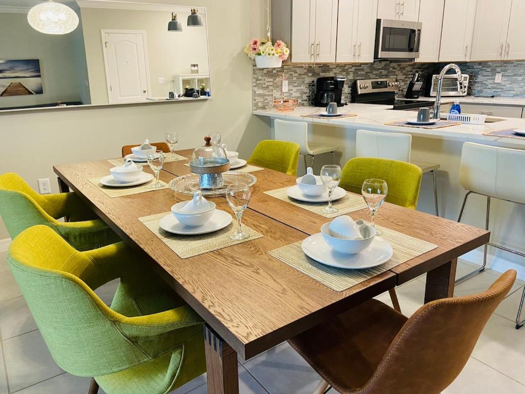 a wooden table with chairs around it in a kitchen at NEW Home 3 Bedrooms Water View Disney Universal in Kissimmee