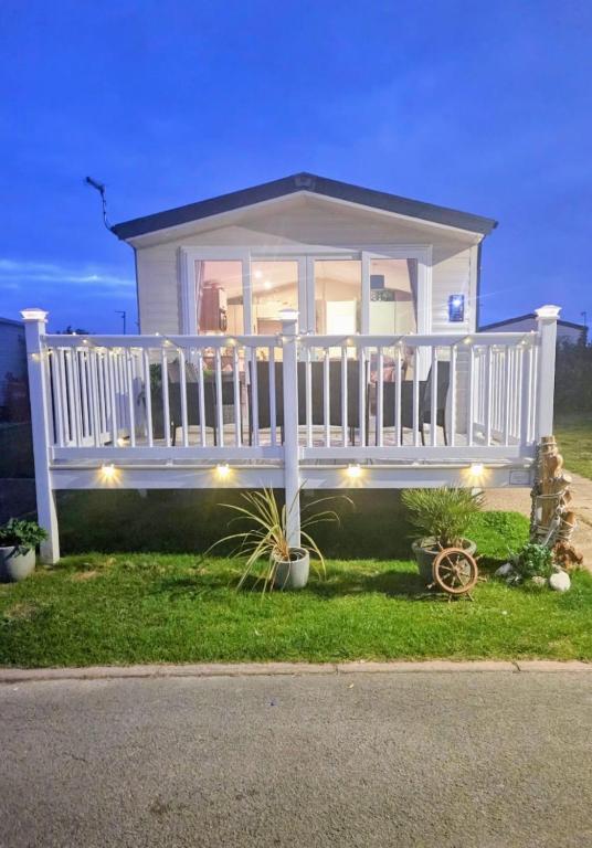 a house with a white railing and a porch at The Mayflower in Skipsea
