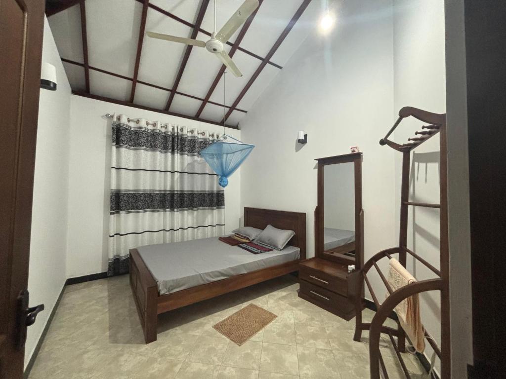 a bedroom with a bed and a blue umbrella at Solara Holiday Homes in Anuradhapura