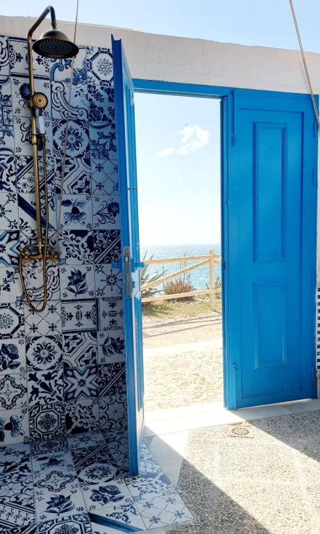 a blue door leading into a bathroom with a beach at Villa Blue beach Tabarca in Tabarca