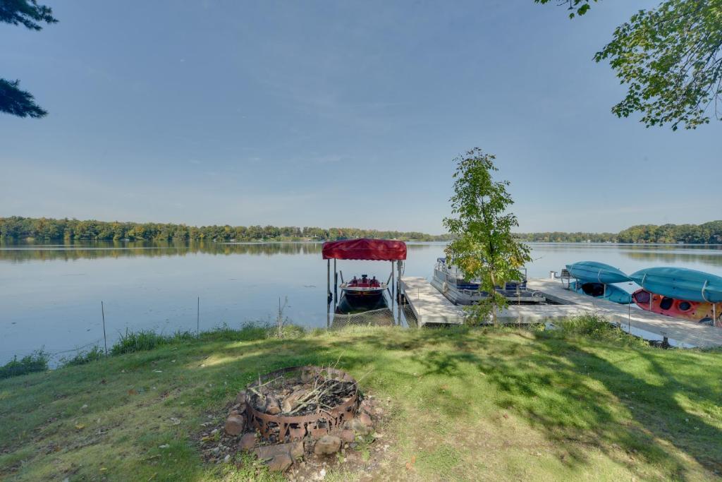 a group of boats parked on the shore of a lake at Big Fish Bay Hideaway - Rice Lake Home with Dock! in Rice Lake