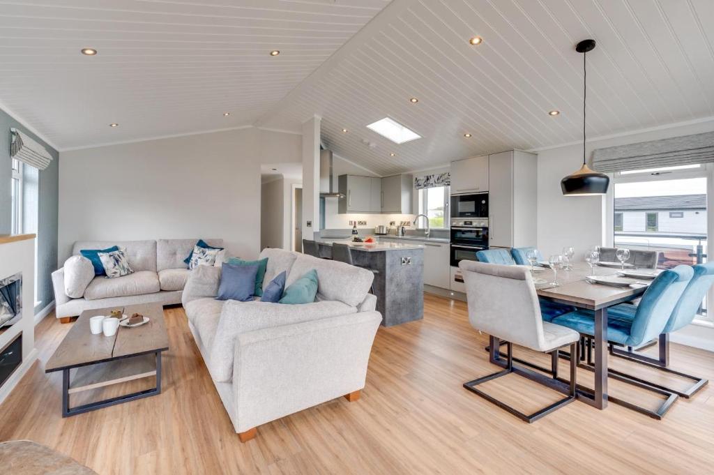 a living room with a couch and a table at Briargate 38 in Burnham Market
