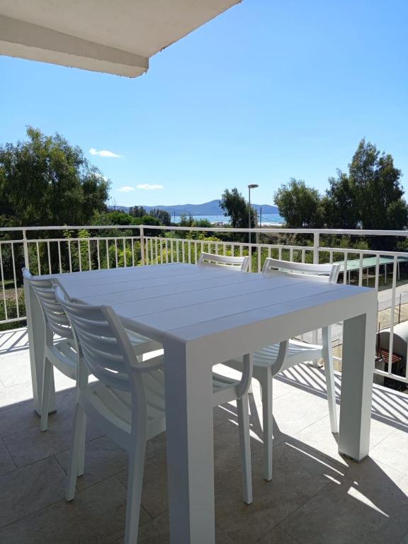 a white table and chairs on a balcony at Solleone - Appartamento 9C in Paestum