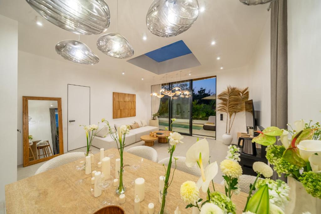 a living room with a table with flowers on it at Ardhana 11 - Brand New Villa with Private Pool - Ungasan in Ungasan