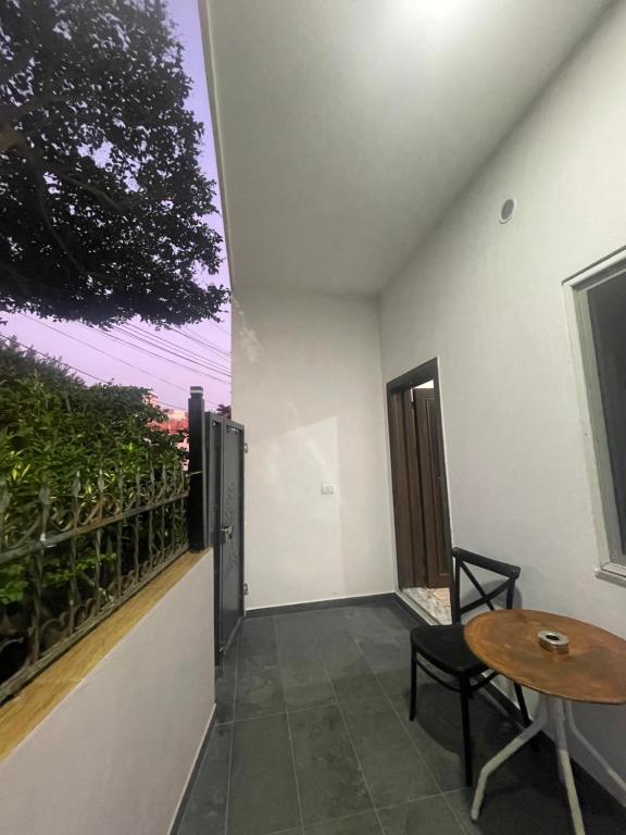 a balcony of a house with a table and a window at Durrës Beach Apartments in Durrës