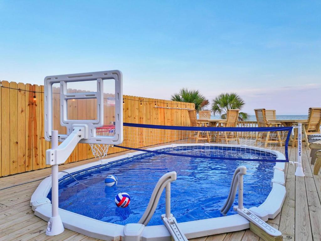a swimming pool with a basketball hoop and a basketball hoop at Pooldreamz! Beachfront Heated Salt Pool! Sleep24! in Caplen