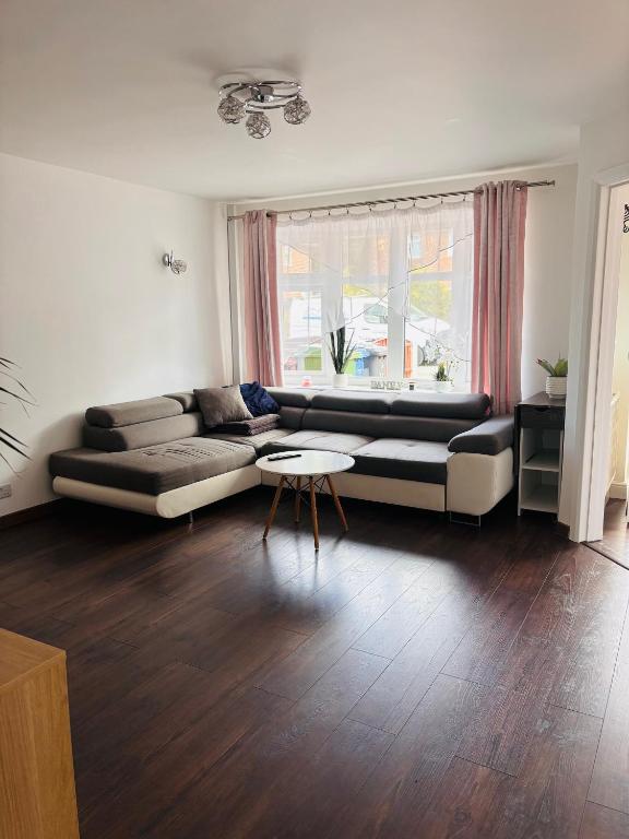 a living room with a couch and a table at Piotr House in Warrington