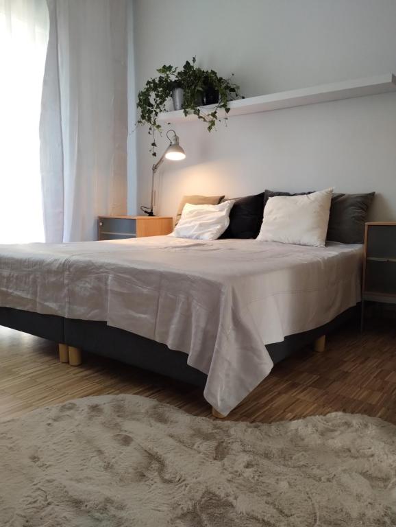 a bedroom with a large bed with white sheets and pillows at MIKO apartament in Mikołów
