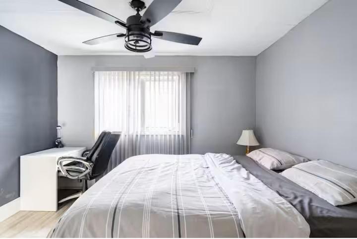 a bedroom with a bed and a ceiling fan at Bungalow in a Quiet Neighborhood in Waterloo