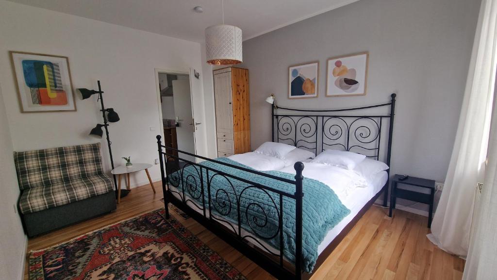 a bedroom with a black bed with white pillows at Aasee Apartments in Münster