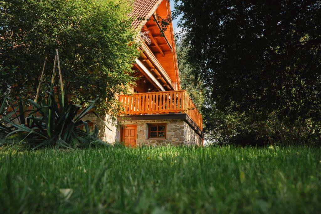 a house with a deck on the side of it at Chata pod Szczeblem in Lubień
