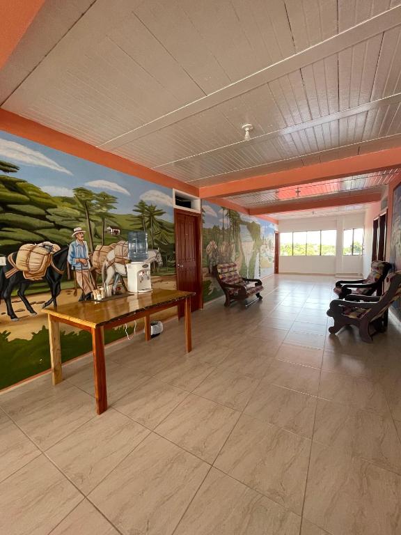 a large room with a painting on the wall at Hotel Marquez in Norcasia