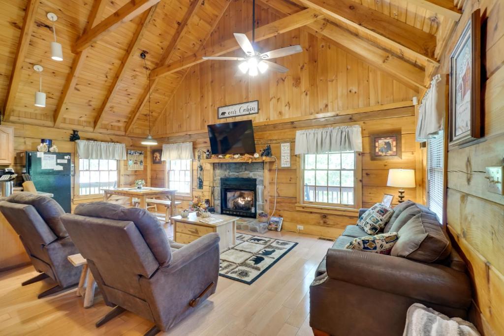 a living room with a couch and a fireplace at Hot Tub and Deck! Bear Hugs Cabin Near Gatlinburg in Glade
