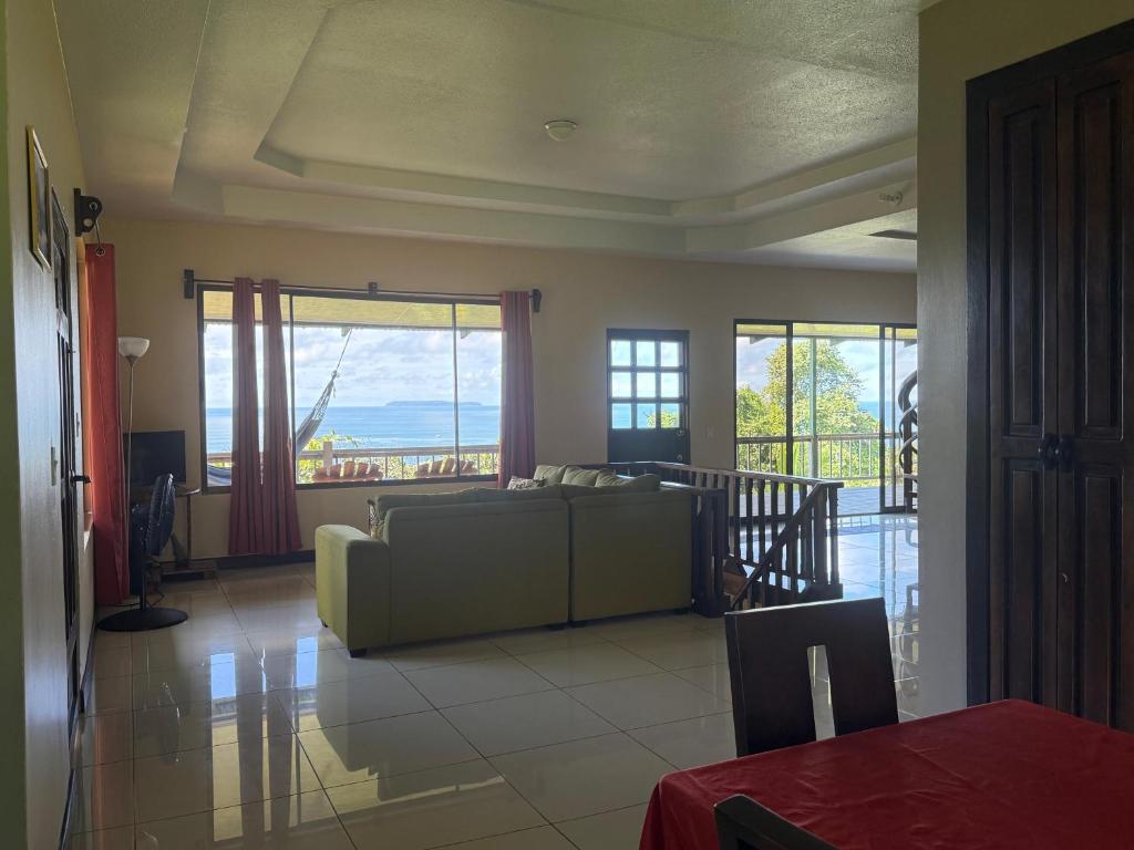 a living room with a couch and large windows at Villa Susan in San Pedrillo