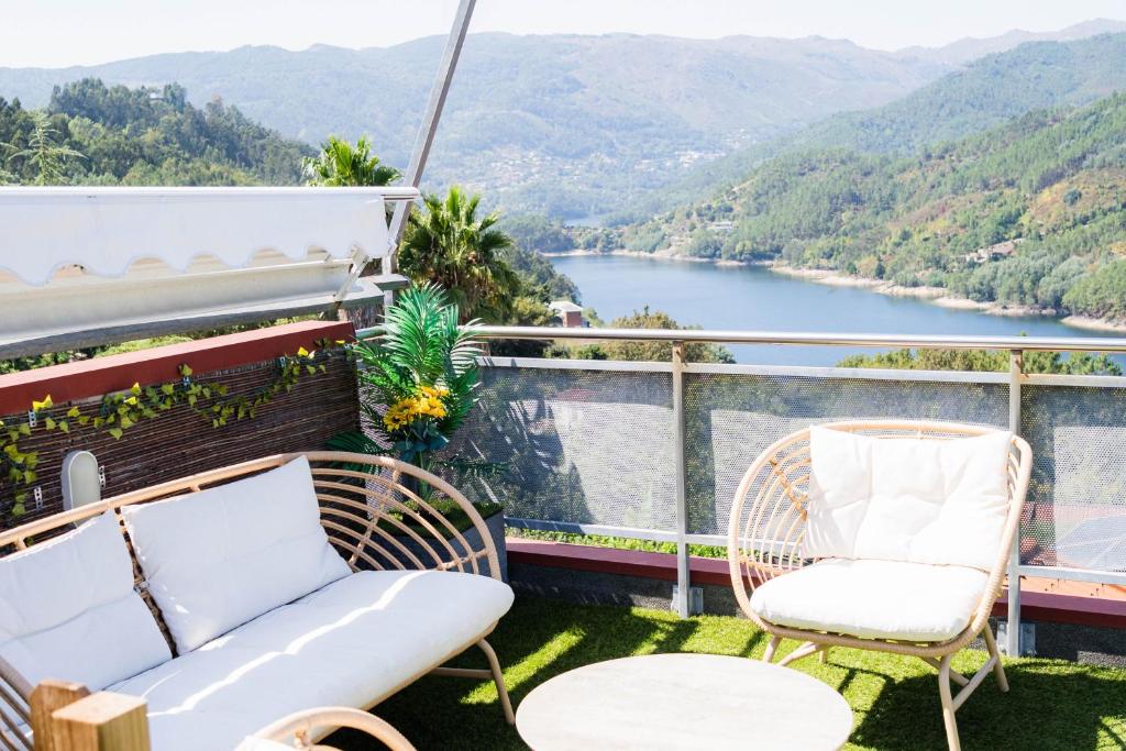a balcony with a view of a river and mountains at Casa do Lagar in Geres