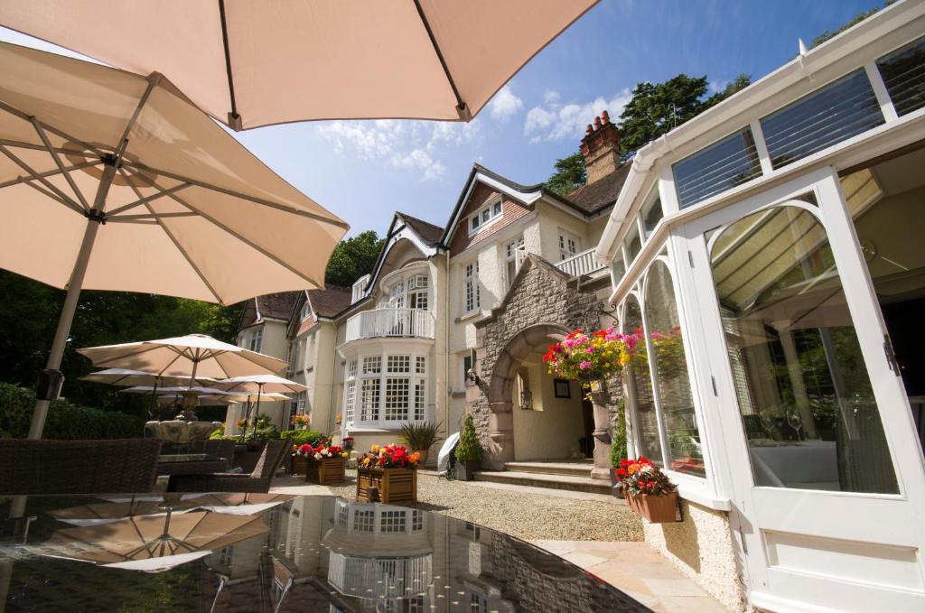 a house with an outdoor patio with an umbrella at Chateau La Chaire in Rozel