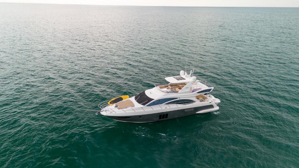 a white boat in the water with people on it at Azimut 58 in Panama City
