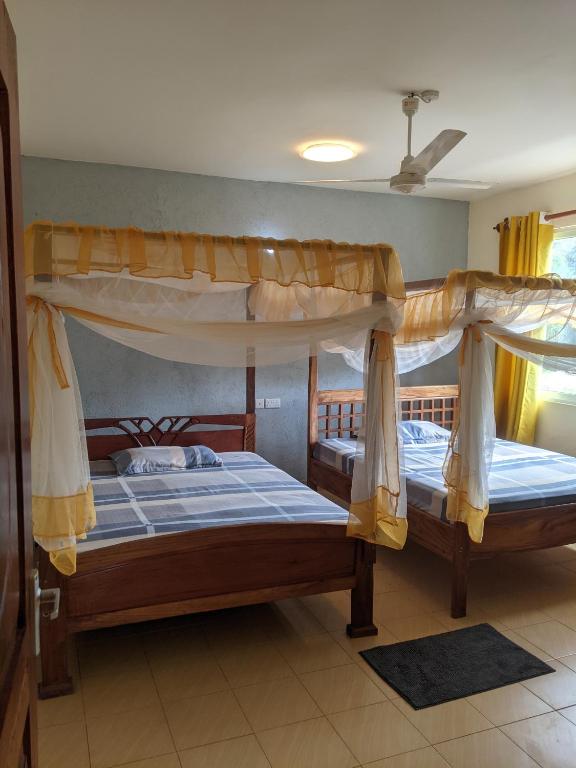 a bedroom with two bunk beds in a room at Haven Homes one bedroom in Diani Beach