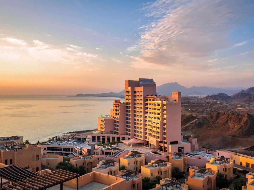 an aerial view of a city and the ocean at Fairmont Fujairah Beach Resort in Al Aqah