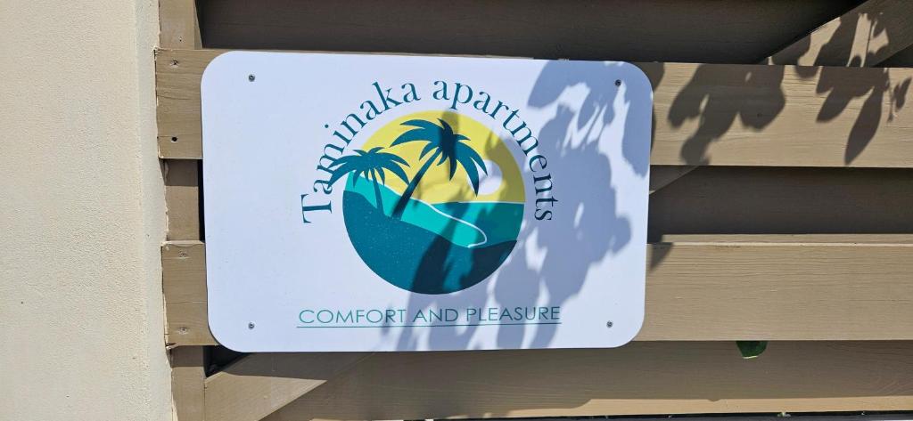 a sign for a tropicalapartment at Taminaka Apartamento Comfortable III in Paradijs