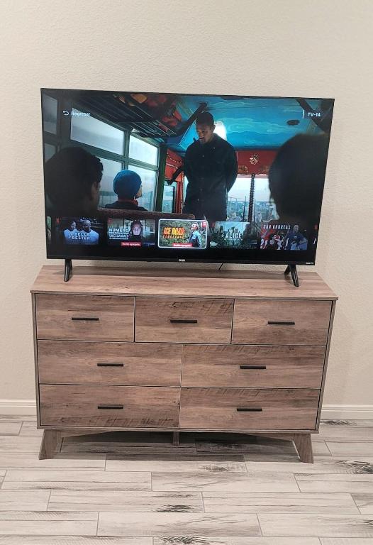 a flat screen tv sitting on top of a dresser at Simon's casitas! in McGregor