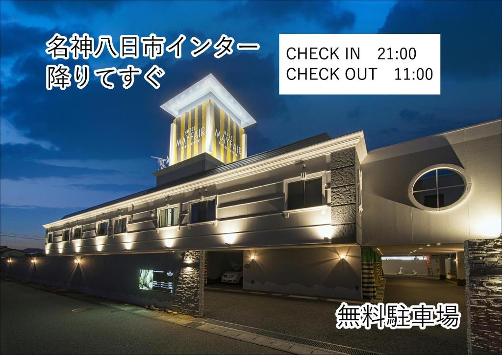 a building with a sign that reads check in check out at ホテルメイフェア Adult Only 男塾ホテルグループ in Yōkaichi