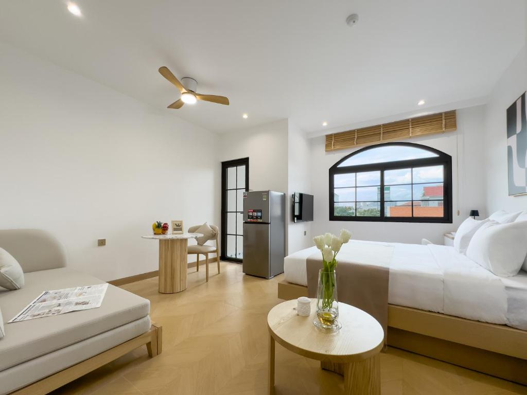 a bedroom with a bed and a living room at CityHouse - Nest Metro Thảo Điền in Ho Chi Minh City