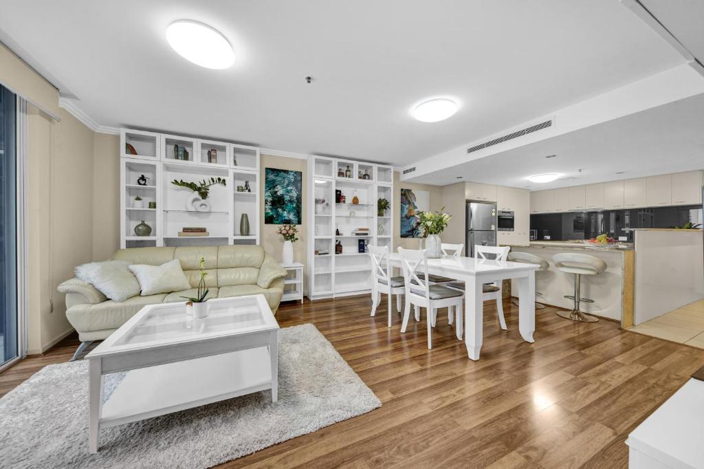 a living room with a couch and a table at Mary Suites Brisbane City in Brisbane