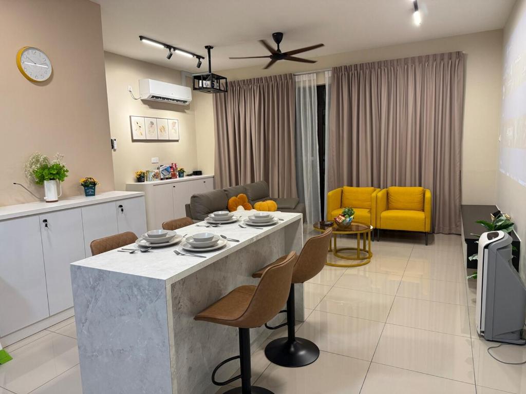 a kitchen and living room with a table and chairs at MountAustin Projector 3BR 8pax NEW in Johor Bahru