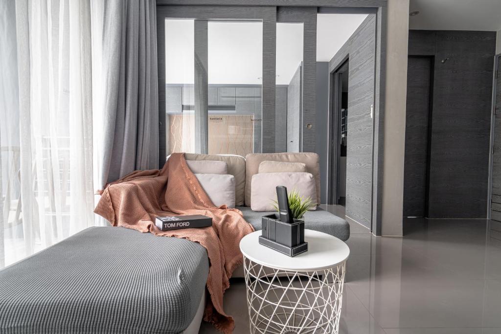 a living room with a couch and a table at Luxury 1BR Apt Kamala Beach Resort B413 in Kamala Beach