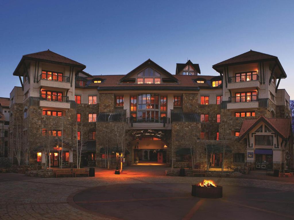 a large building with a fire in front of it at Fairmont Heritage Place, Franz Klammer Lodge in Telluride