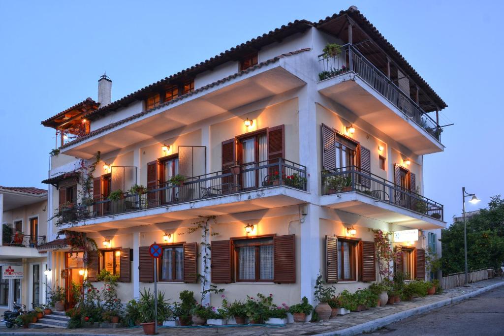 a large white building with windows and balconies at Pension Posidon in Olympia