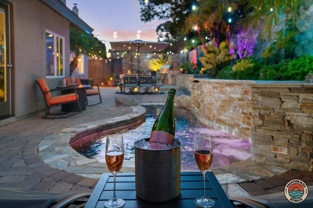 a bottle of wine sitting on a table with two glasses at The Palmera in Oceanside