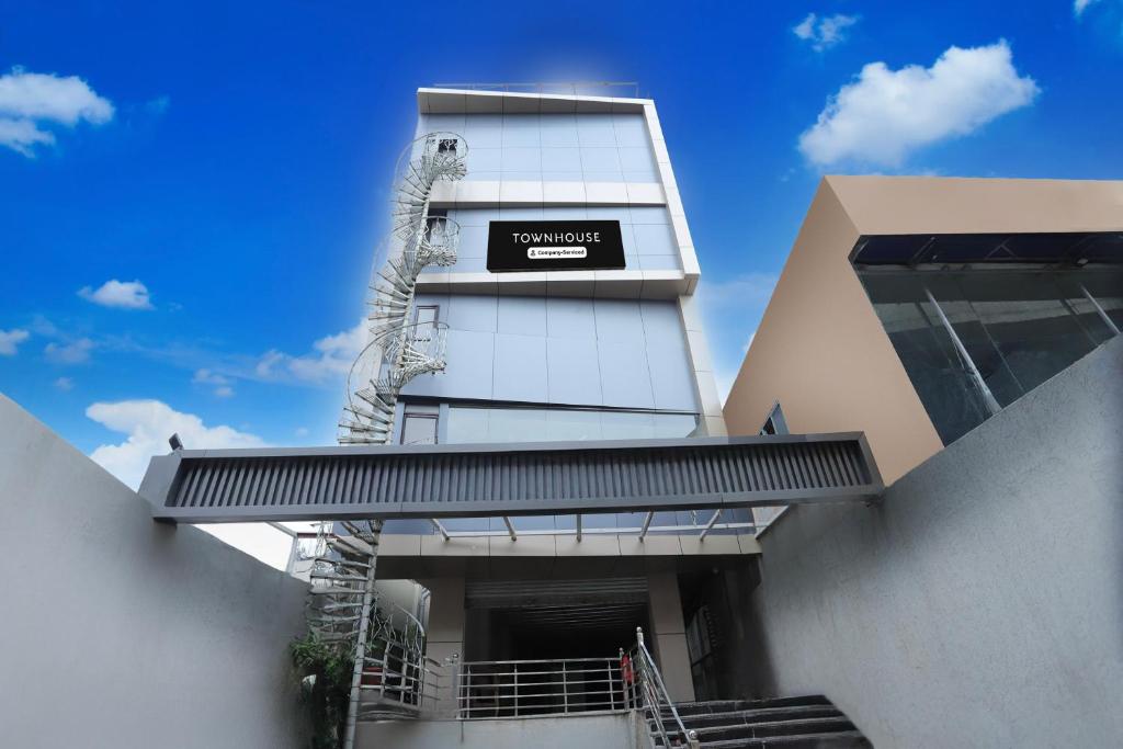 a building with a sign on the side of it at Super Townhouse Rauniyar City Centre Ratu Road in Rānchī