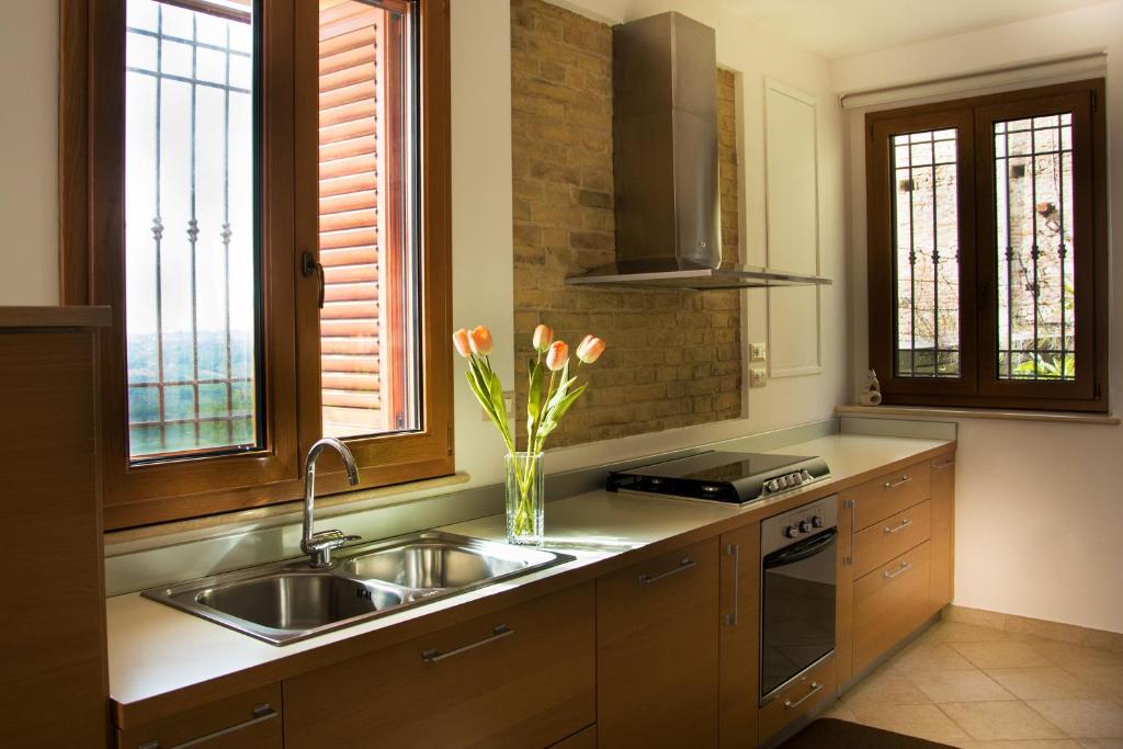 una cocina con fregadero y un jarrón de flores en B&B Porta Della Noce, en Lanciano