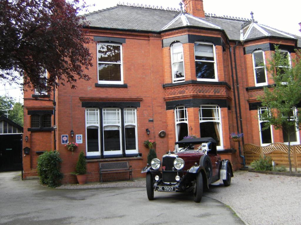 an old car parked in front of a brick house at Bridge House Bed & Breakfast in Newark-on-Trent
