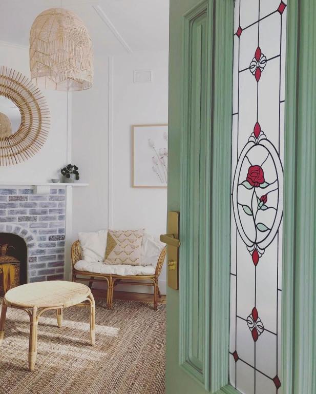 a living room with a door leading into a room with a fireplace at Willow McLaren Vale in McLaren Vale