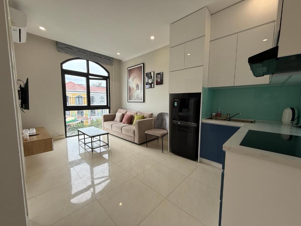 a kitchen and living room with a couch and a table at Three women in Phu Quoc