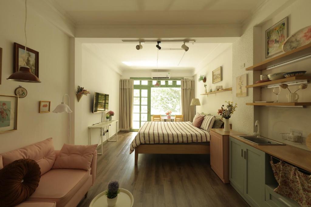 a living room with a couch and a window at Langmandi Experience Ấu Triệu in Hanoi