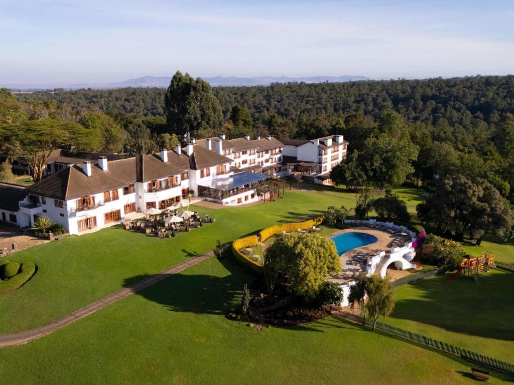 an aerial view of a resort with a swimming pool at Fairmont Mount Kenya Safari Club in Nanyuki