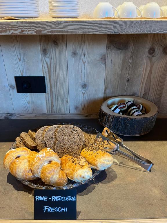 a tray of breads and pastries on a table at Gran Zebrú B&B - high mountain in Valfurva