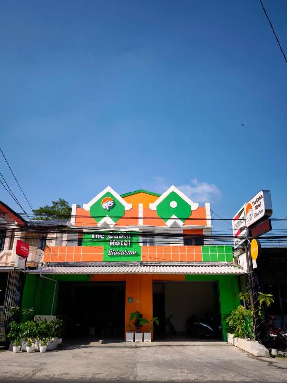 a brightly colored building with a sign on it at The Cabin Hotel Sidoarum in Sleman