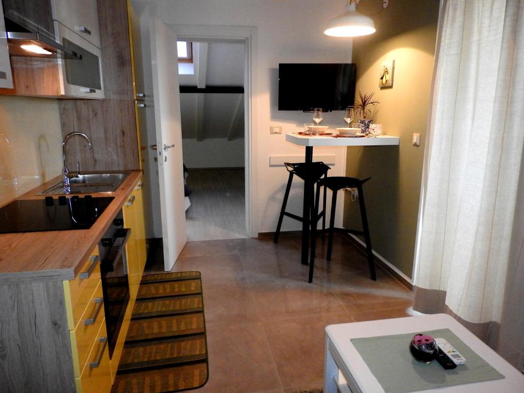 a small kitchen with a sink and a table at Delight Loft in Rovinj
