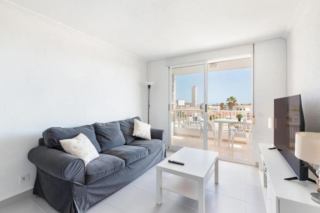 a living room with a couch and a table at Bahía Mar Apartamento in Puerto de Mazarrón