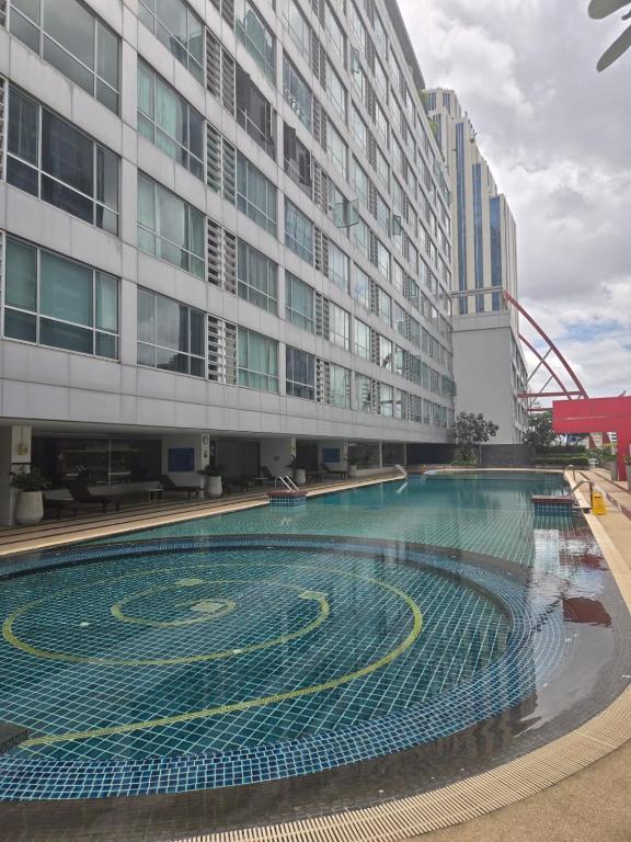 a swimming pool in front of a building at Studio apartment in Trendy Bankok in Bangkok