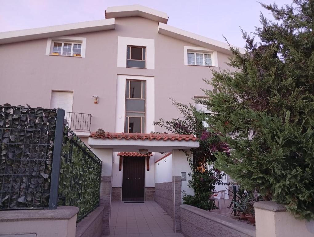 a white house with a gate and a driveway at La Casa di Anna in Sassari