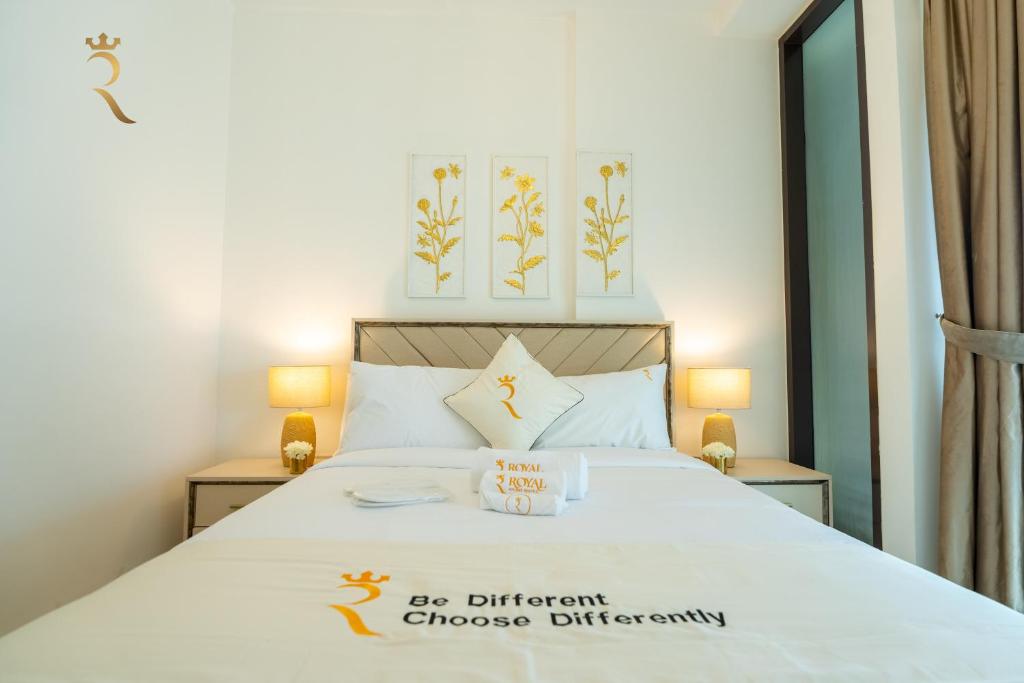 a bedroom with a bed with a sign on it at Al Raha Beach Elegant 2BR Apartment with Private Balcony in Abu Dhabi