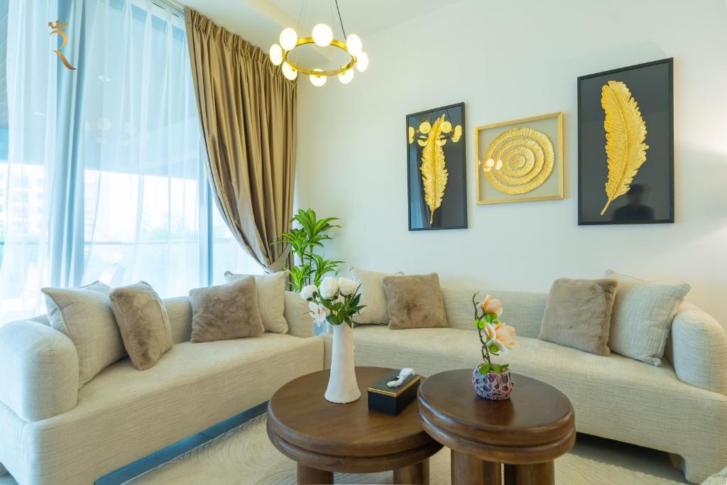 a living room with a couch and a table at Al Raha Beach Elegant 2BR Apartment with Private Balcony in Abu Dhabi